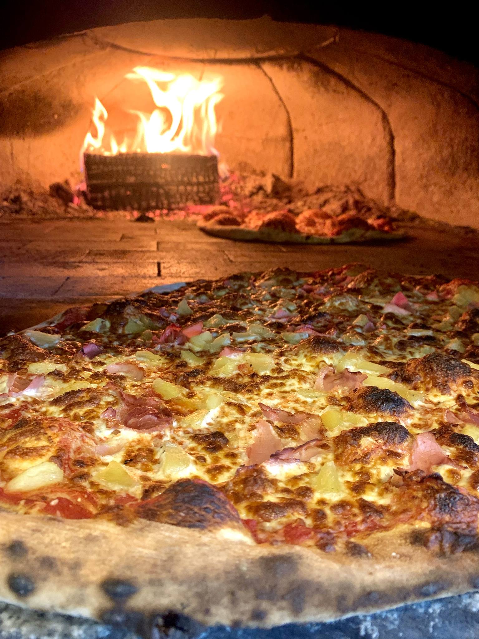 Chef's special wood oven pizza with seasonal ingredients - Award winning pizzeria Canada