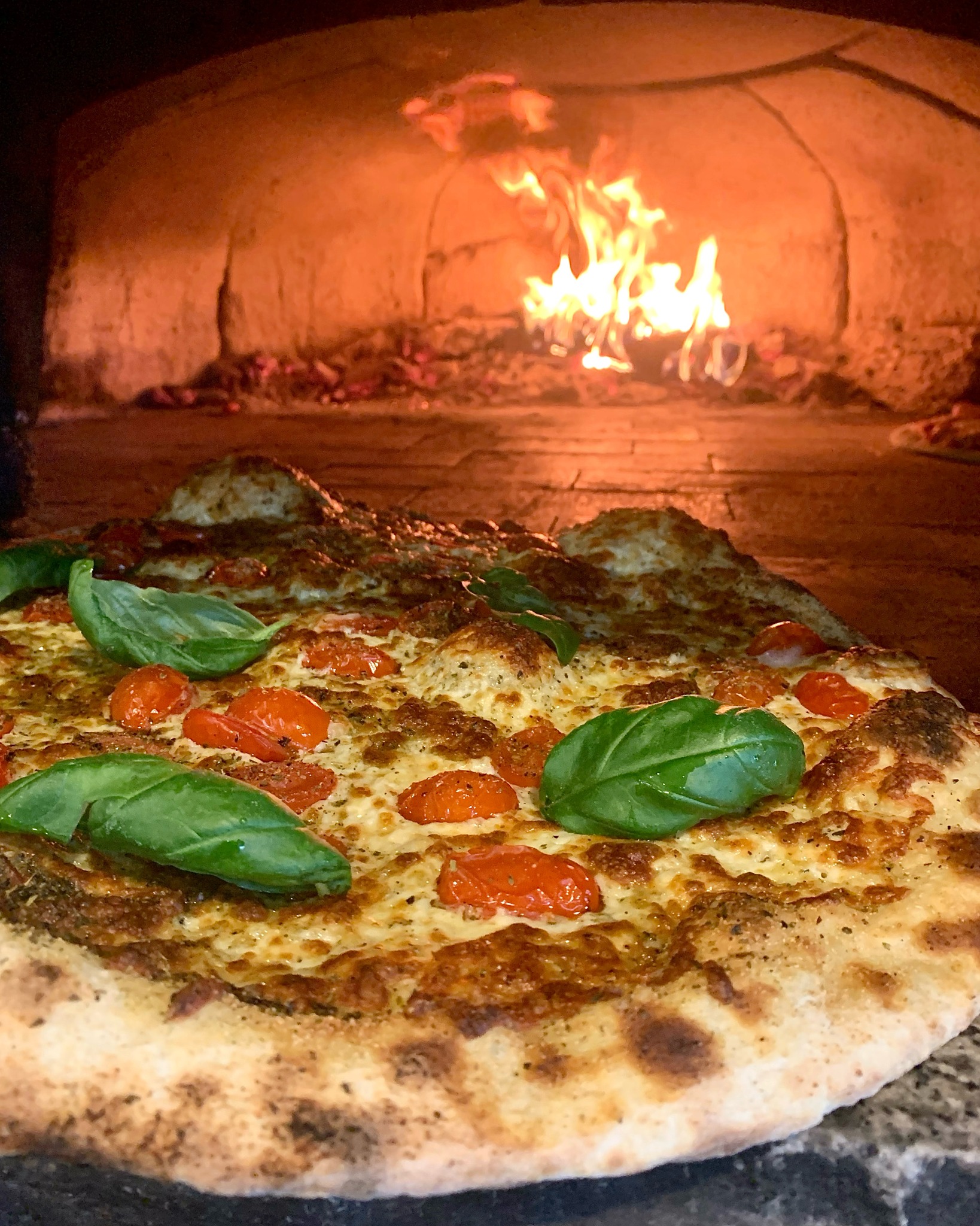 Classic wood fired pizza with fresh mozzarella and basil - Italian restaurant Pitt Meadows